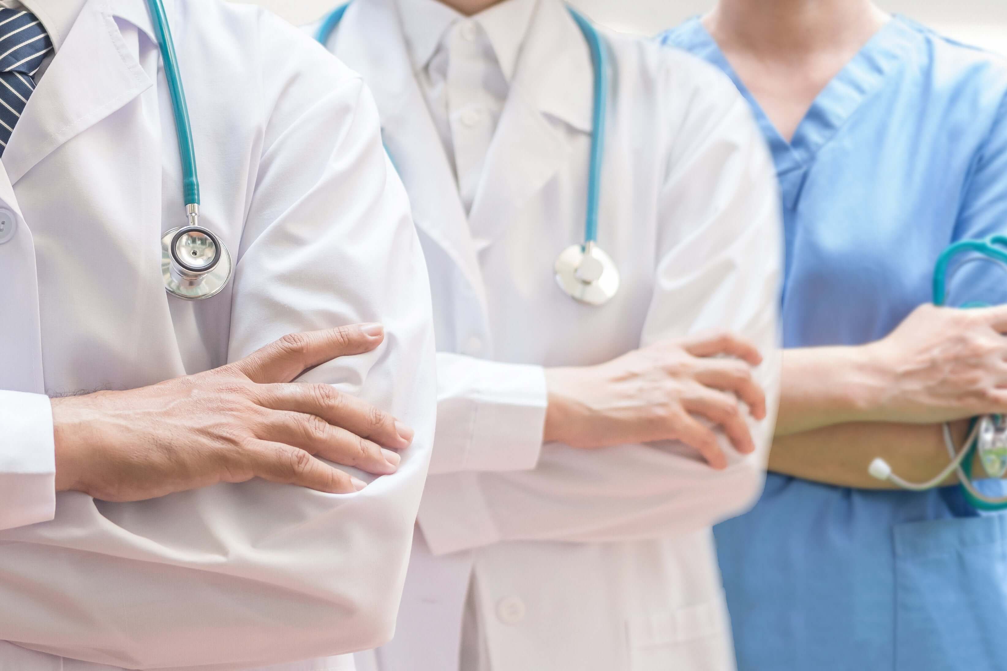 Group of doctors and nurses in a healthcare setting, representing the durable paint coating designed to withstand harsh cleaning and disinfecting chemicals.