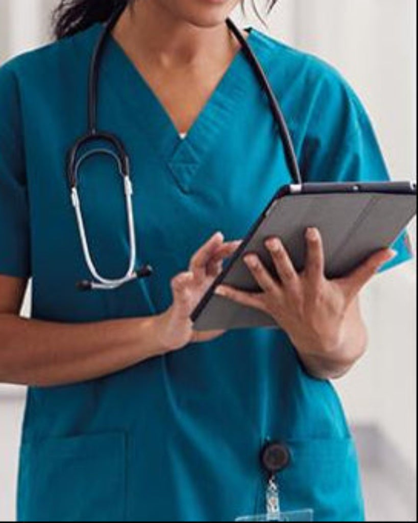 Healthcare worker in scrubs with a stethoscope using a tablet device