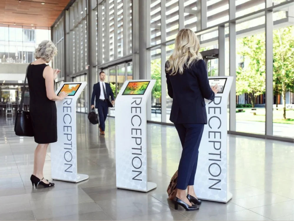 Alur tablet kiosks carrying printed magnetic wayfinding panels in a lobby